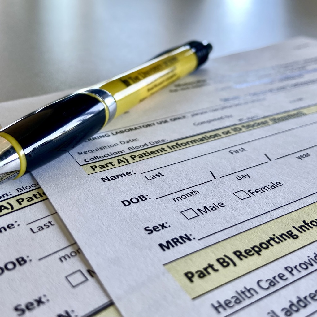 Part of Molecular Otolaryngology and Renal Research Laboratories' requisition form with black and gold pen.
