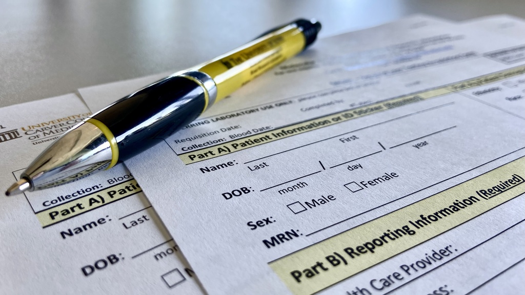 Part of Molecular Otolaryngology and Renal Research Laboratories' requisition form with black and gold pen.